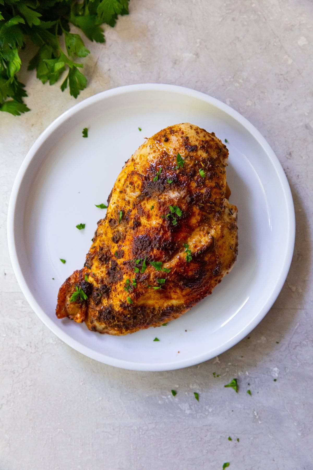 blackened chicken breast on a white plate