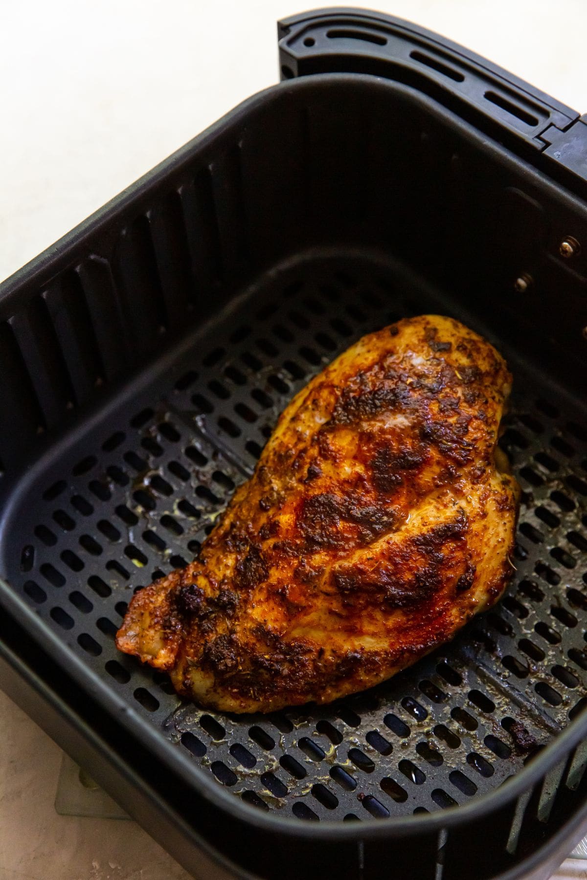 cooked blacked chicken inside Air Fryer