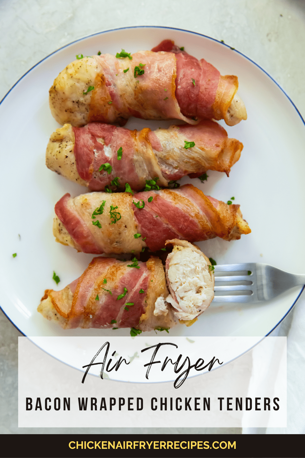 Bacon wrapped chicken tenders one piece cut with a fork in it.