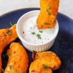 air fryer buffalo chicken tenders on a blue plate with ranch dressing