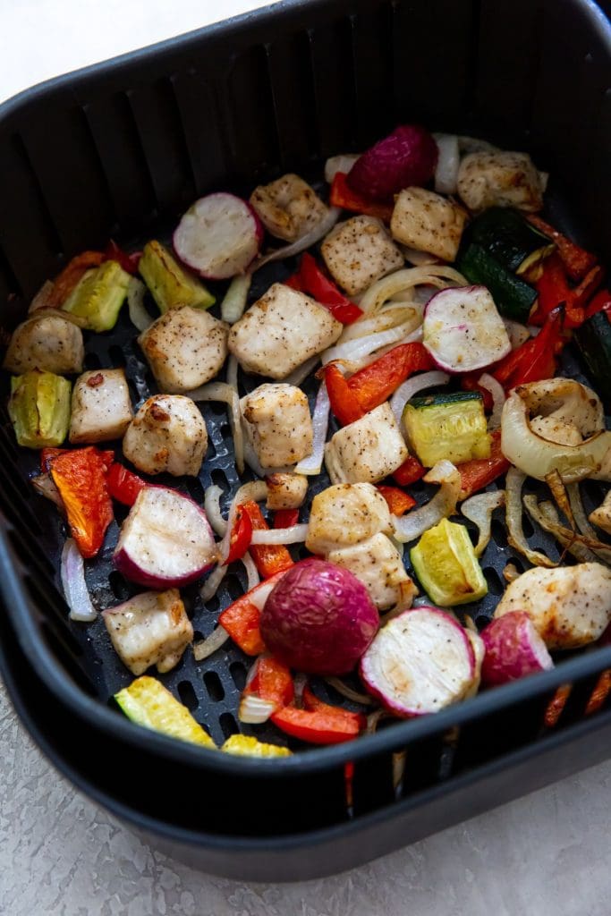 Black Air Fryer with chicken and veggies