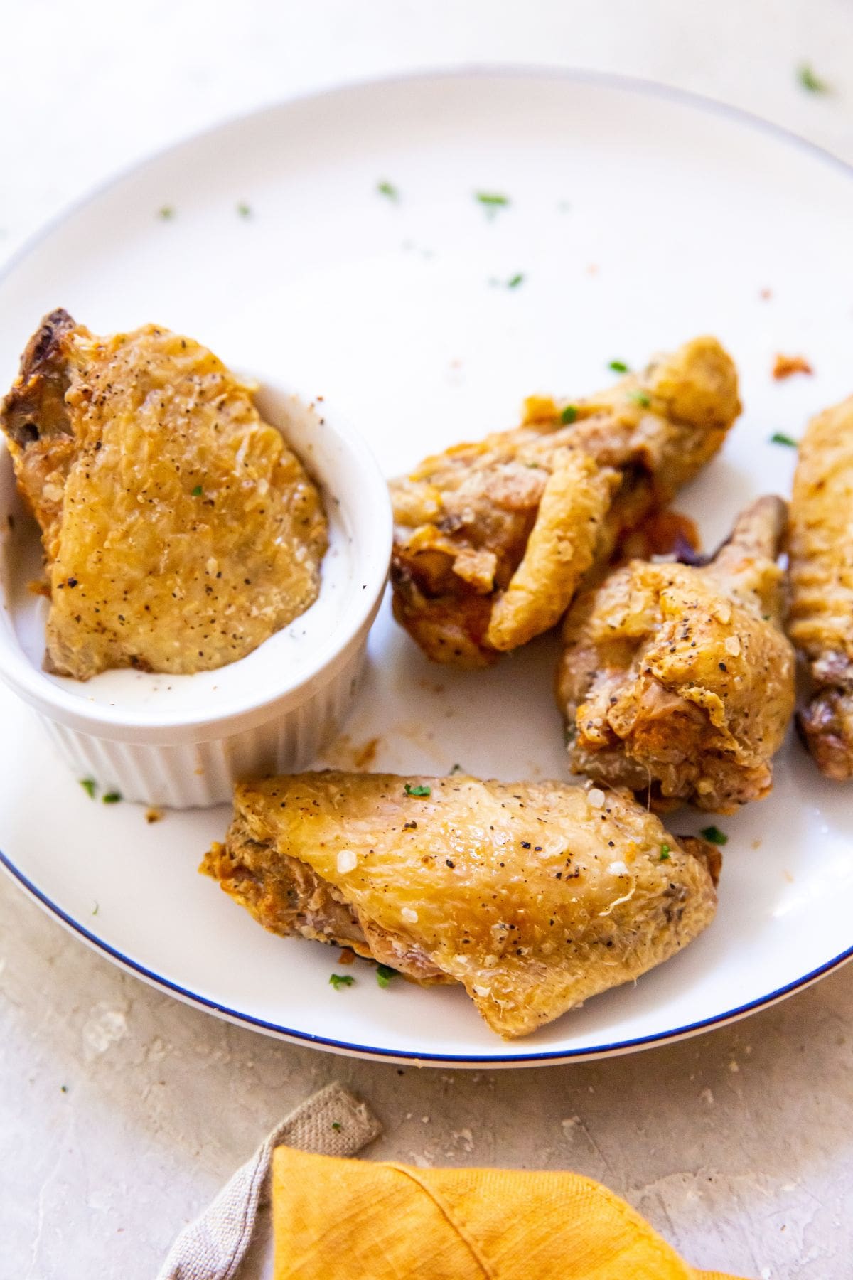 plate of chicken wings. One wing dipped into ranch