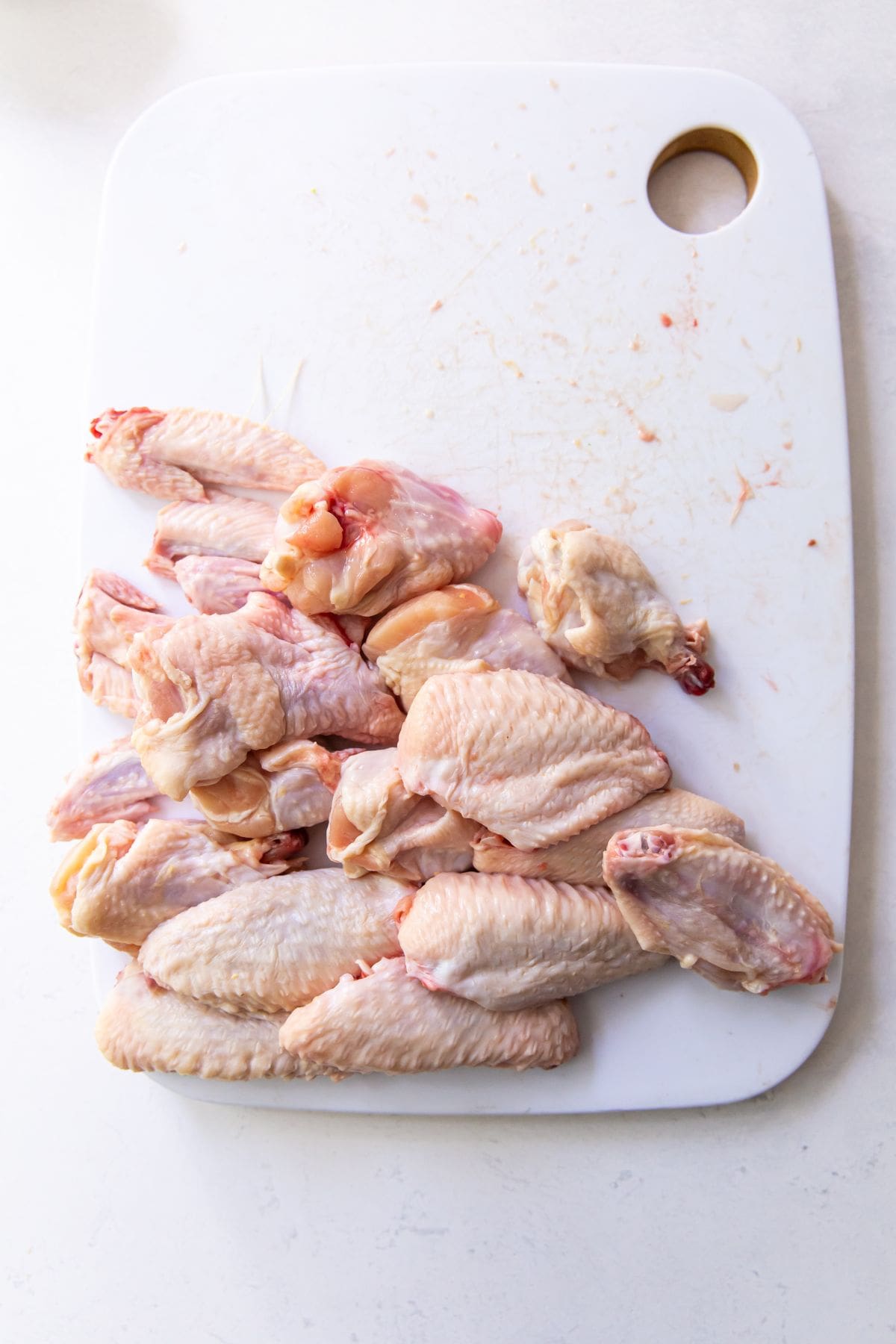 cutting board with chicken wings on it