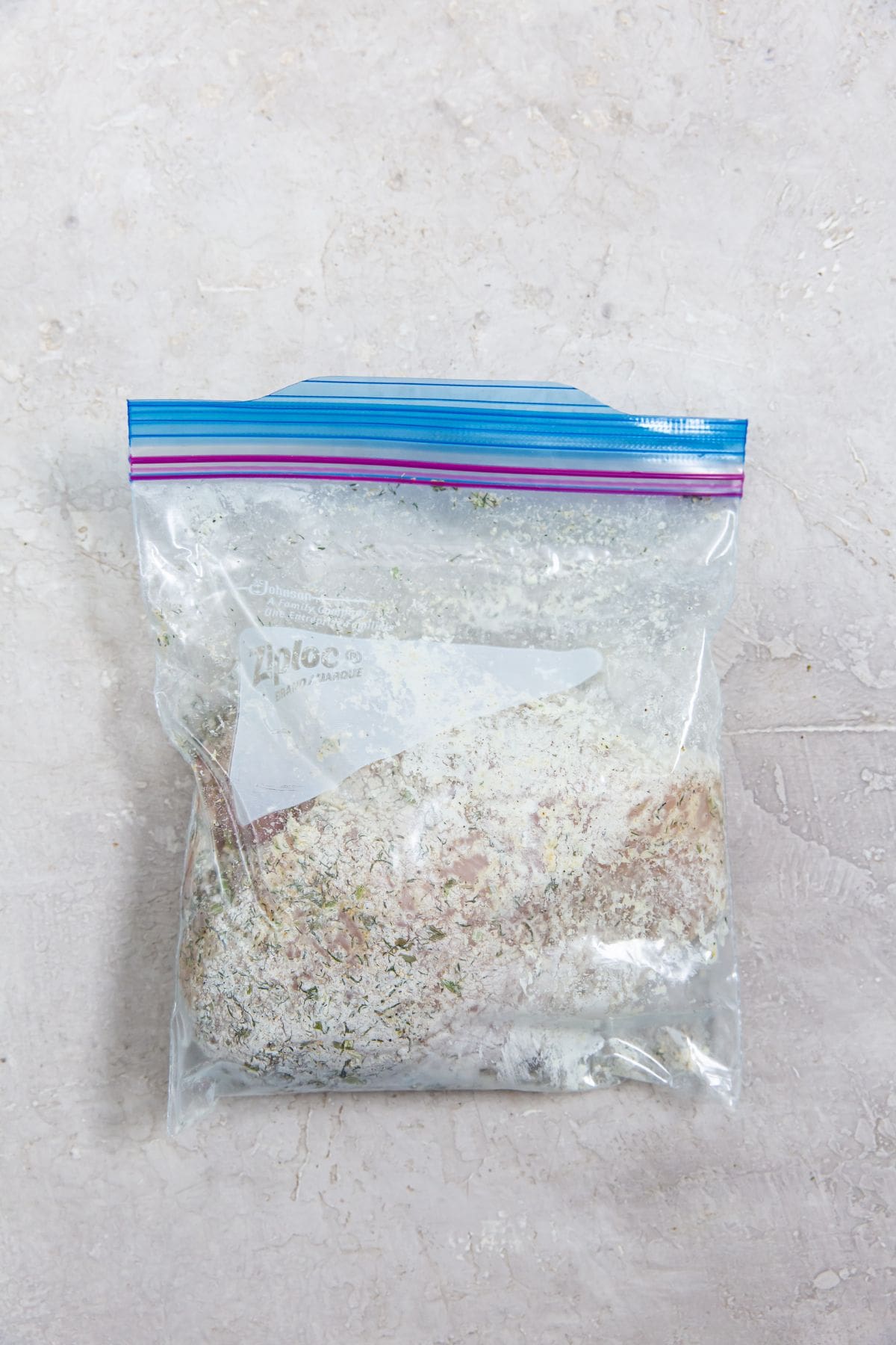 ziplock bag with chicken breast and ranch seasoning inside