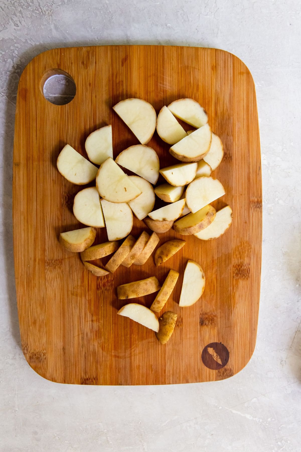 potatoes cut up into cubes on a cutting board