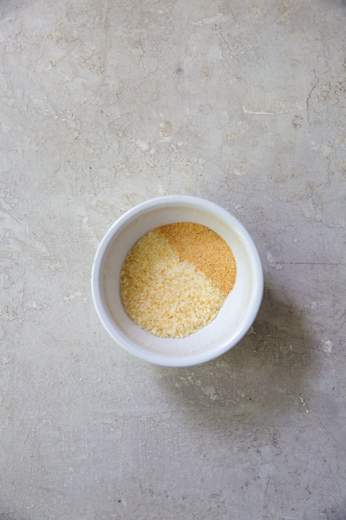 mixing bowl with garlic seasoning and parmesan cheese