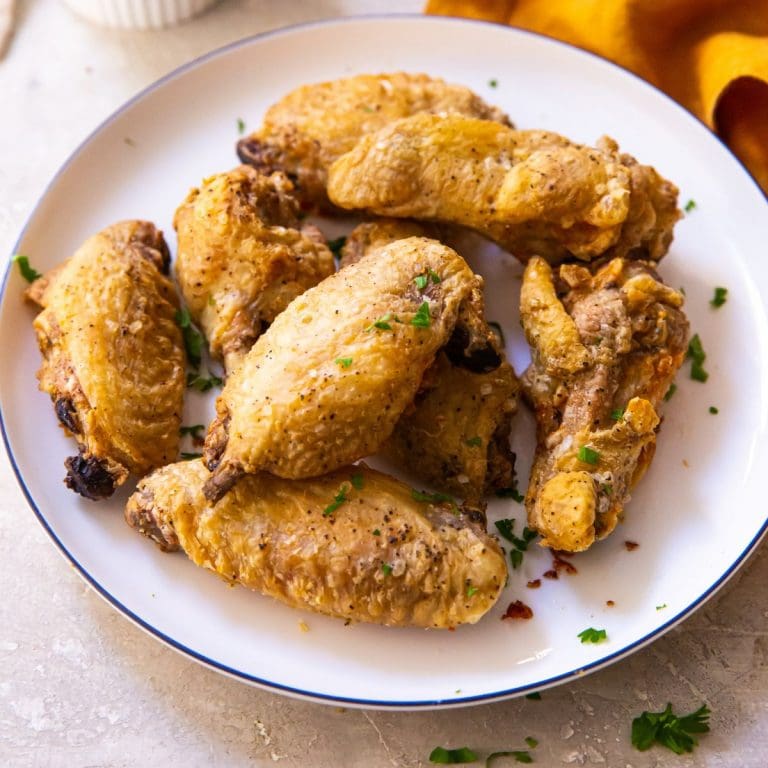 plate of chicken wings orange napkin in the background