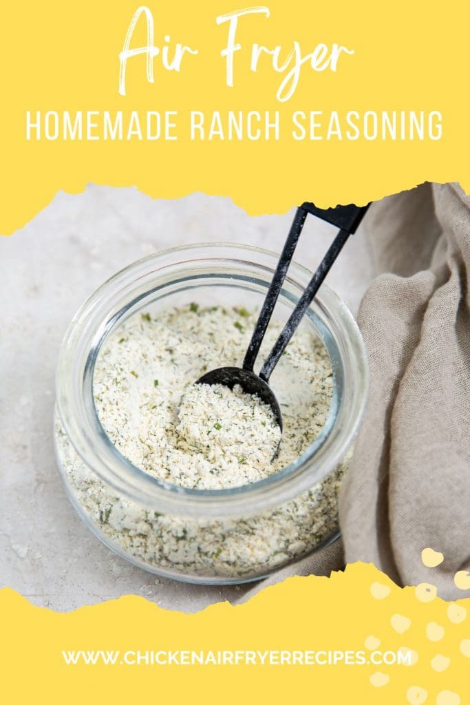 ranch seasoning inside a jar tablespoon inside jar. gray towel next to it