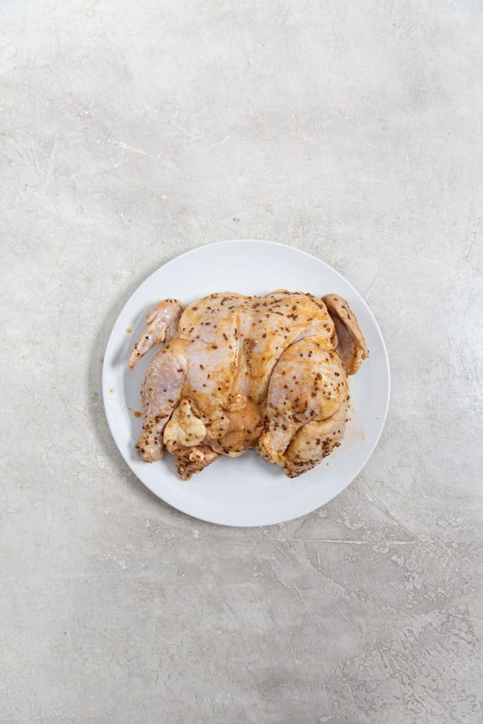 spatchcock chicken on a white plate