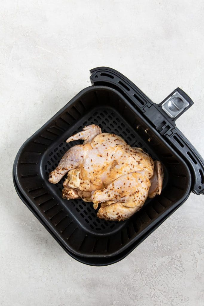 chicken inside a black air fryer basket