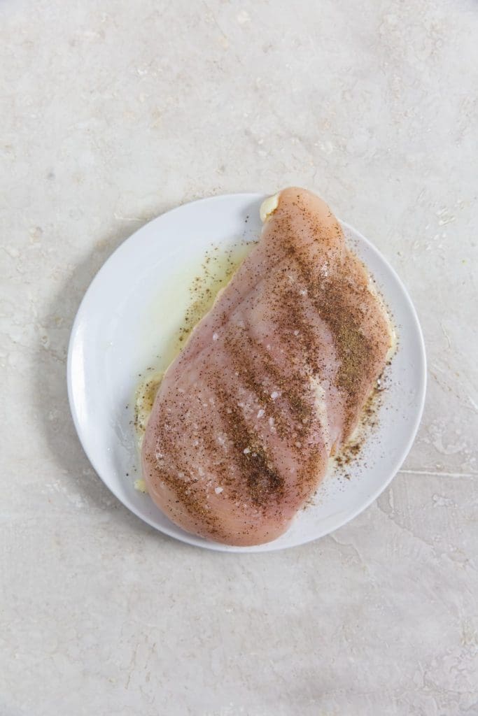 raw chicken on a white plate