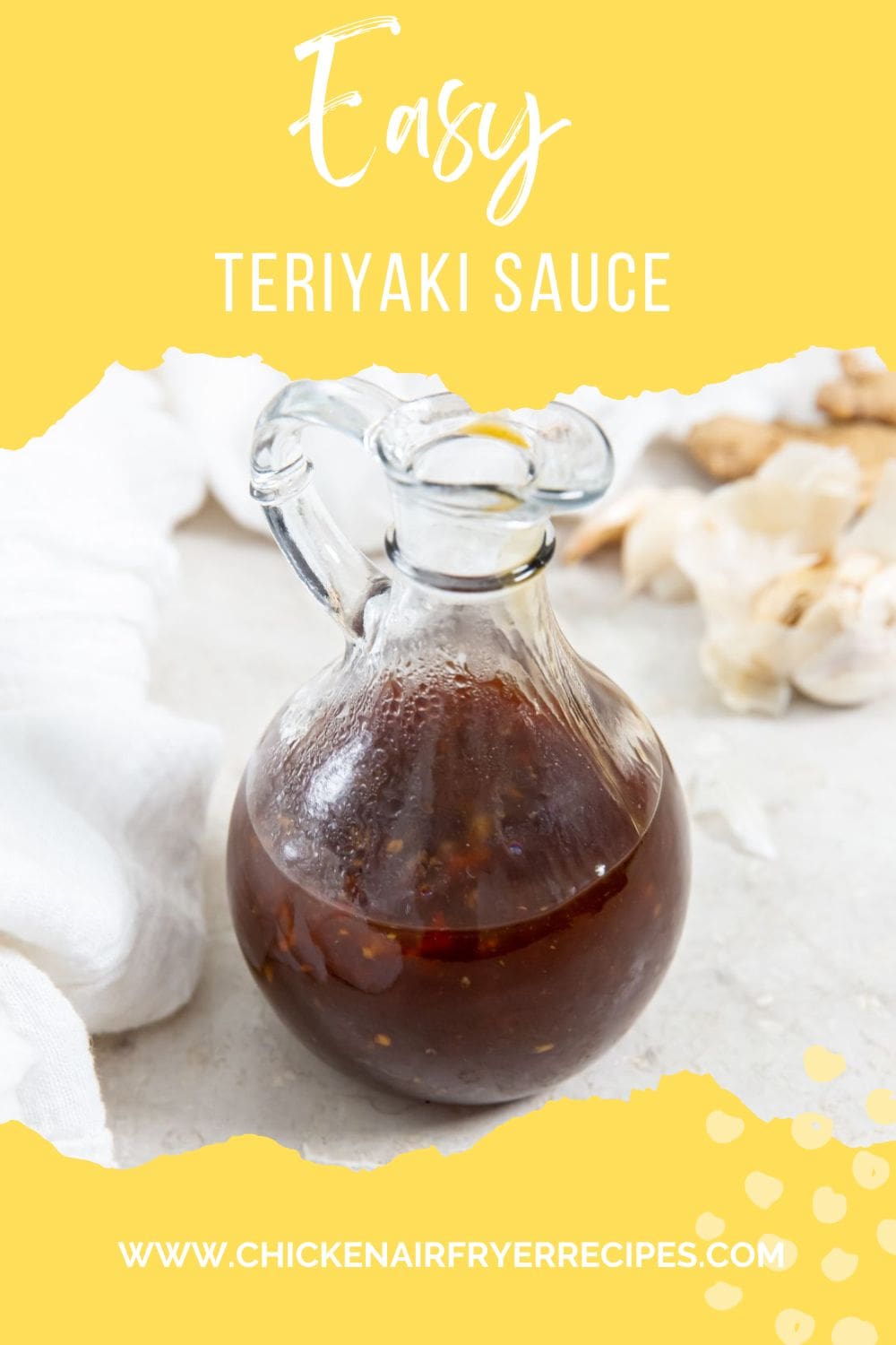 glass dressing bottle with teriyaki sauce inside white napkin in the back along with fresh garlic and ginger