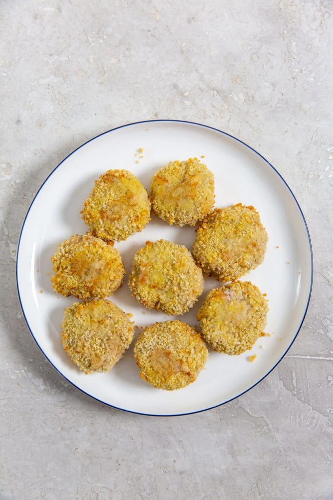 white plate with chicken nuggets on it