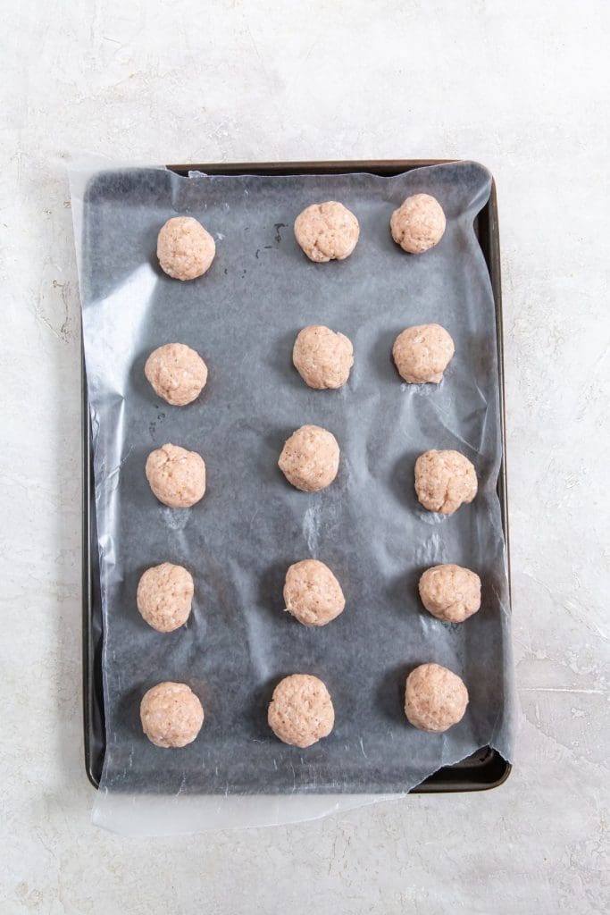 cooking sheet with ground chicken balls on it