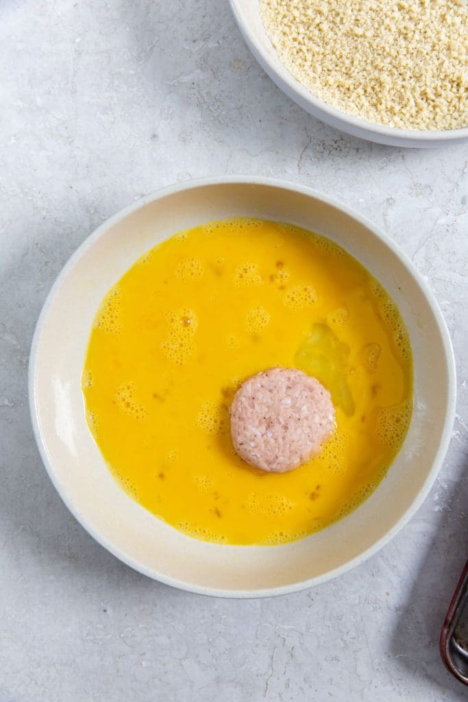 bowl with eggs and one chicken nugget inside.