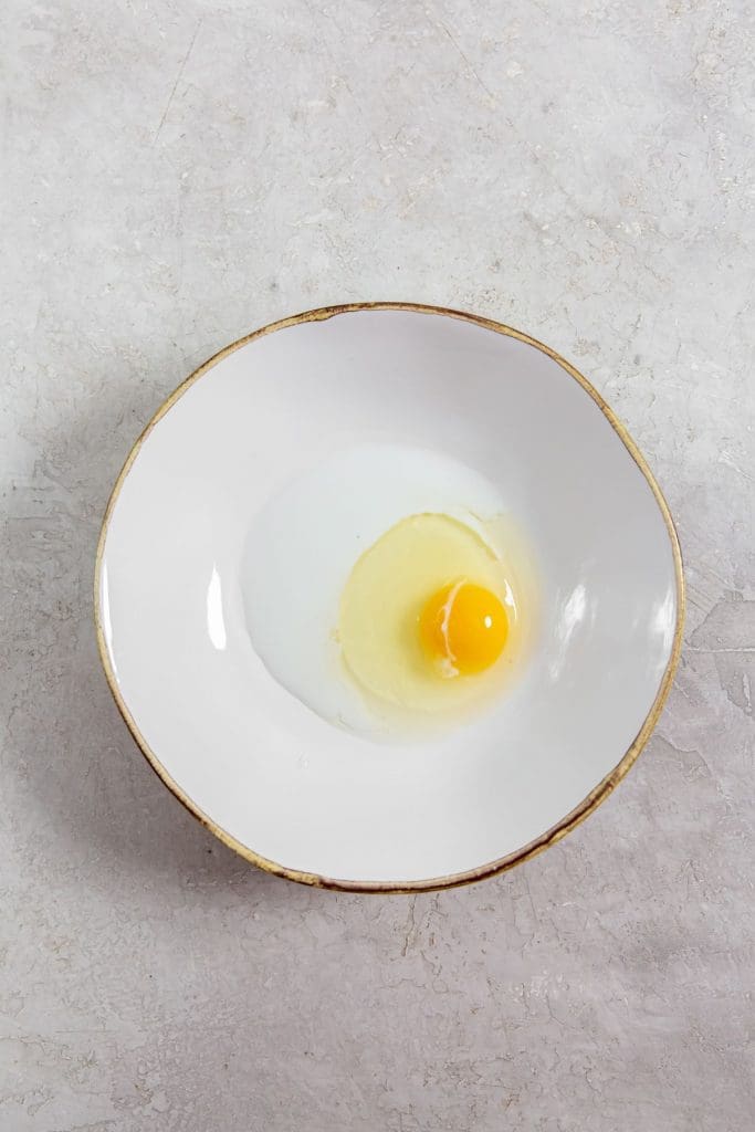 white bowl with milk and egg