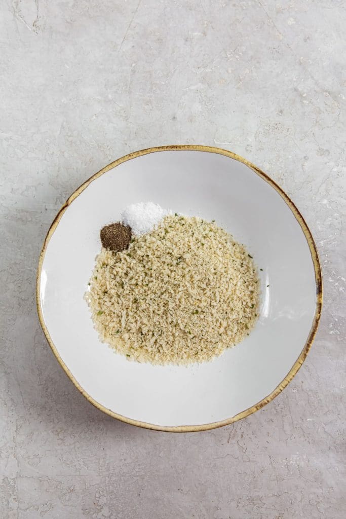 white bowl with bread crumbs and salt and pepper