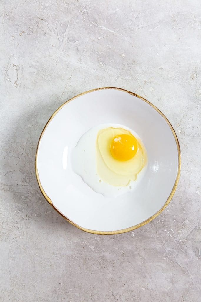 white bowl with milk and egg inside