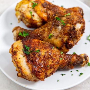 white plate with chicken parsley in the back