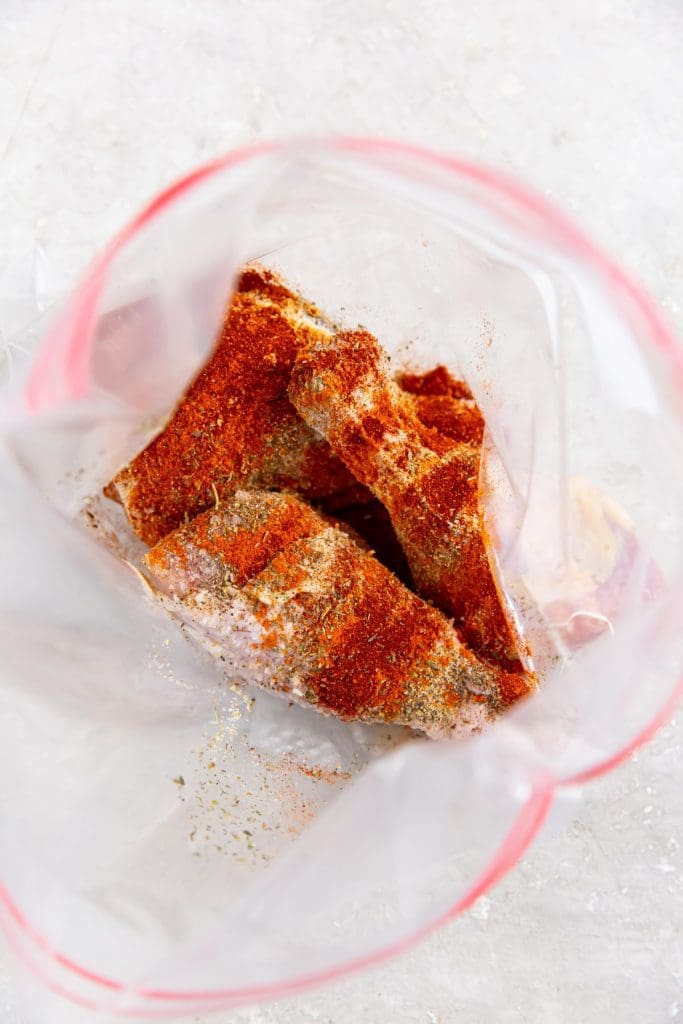 ziplock bag with chicken and seasoning inside