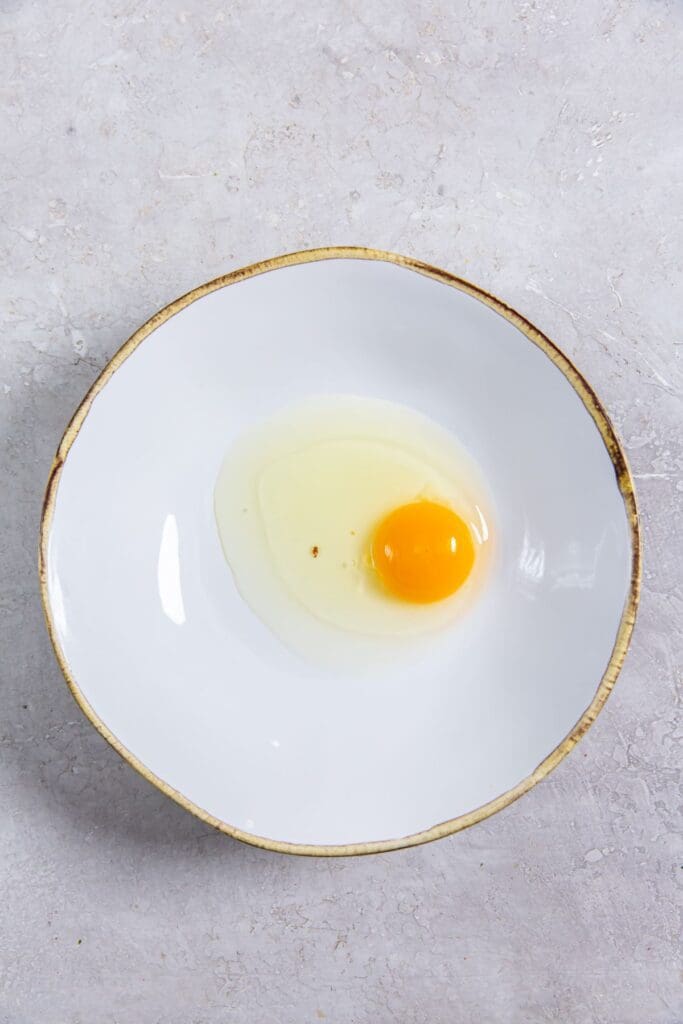 white bowl with egg inside