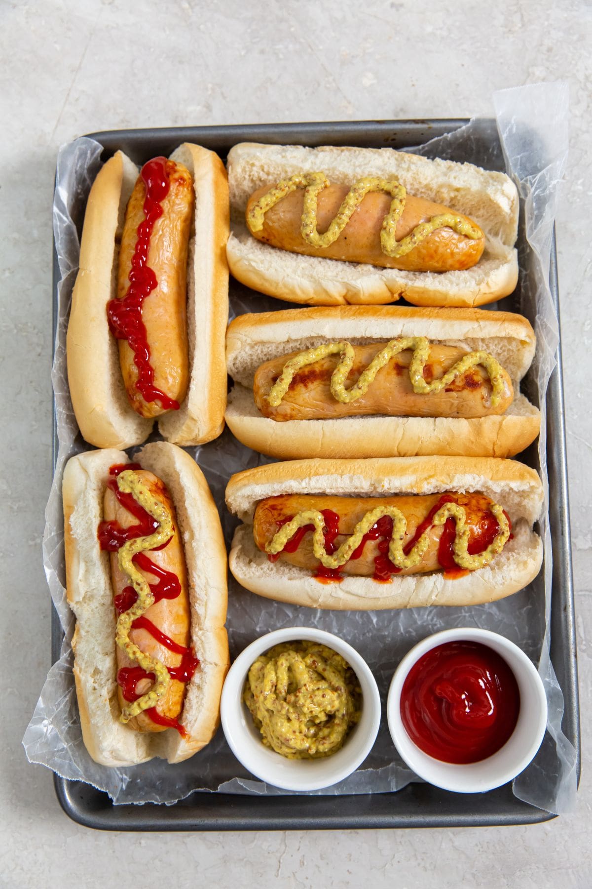 Chicken sausage in hot dog buns. mustard and ketchup on them