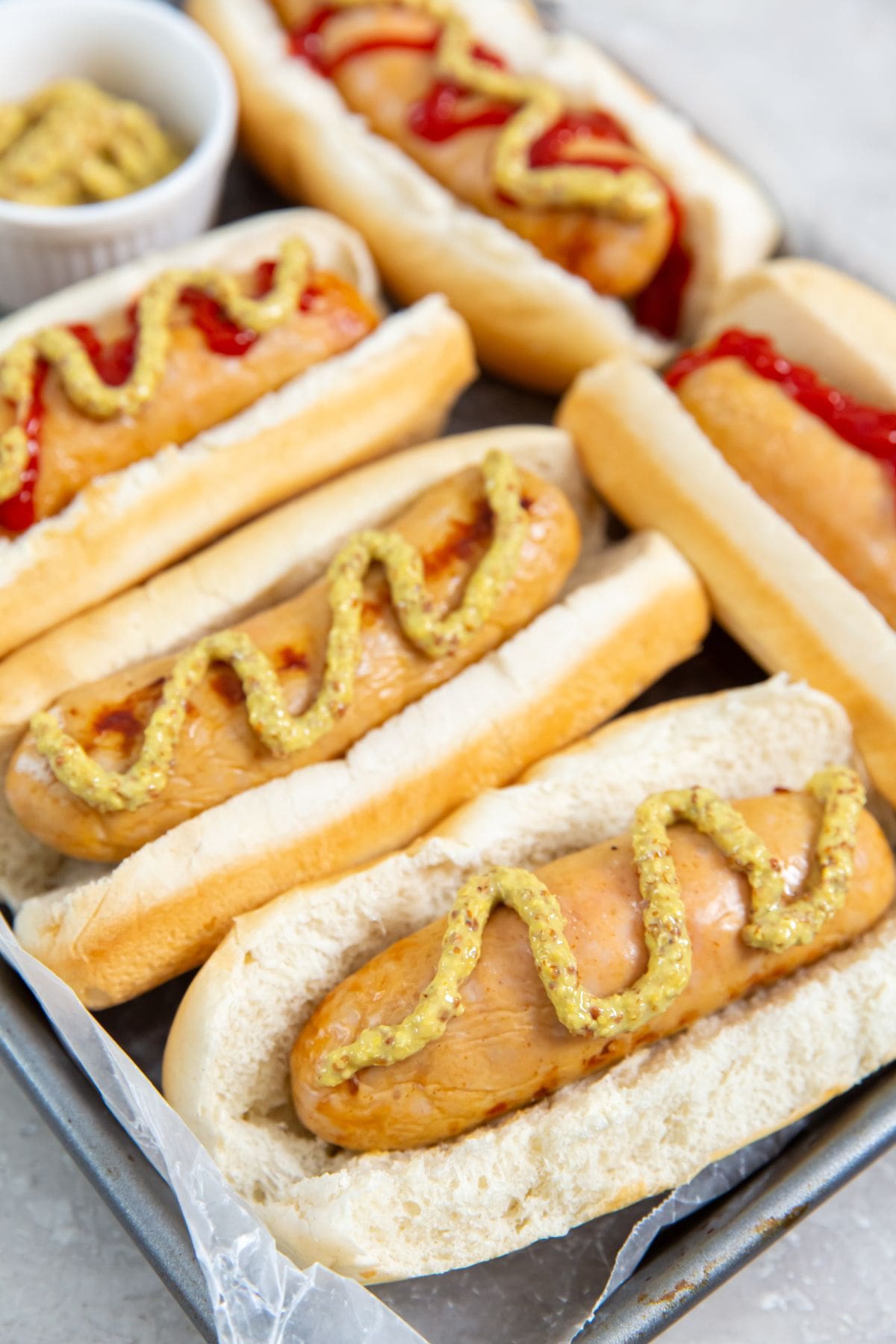 Chicken sausage in hot dog buns. mustard and ketchup on them