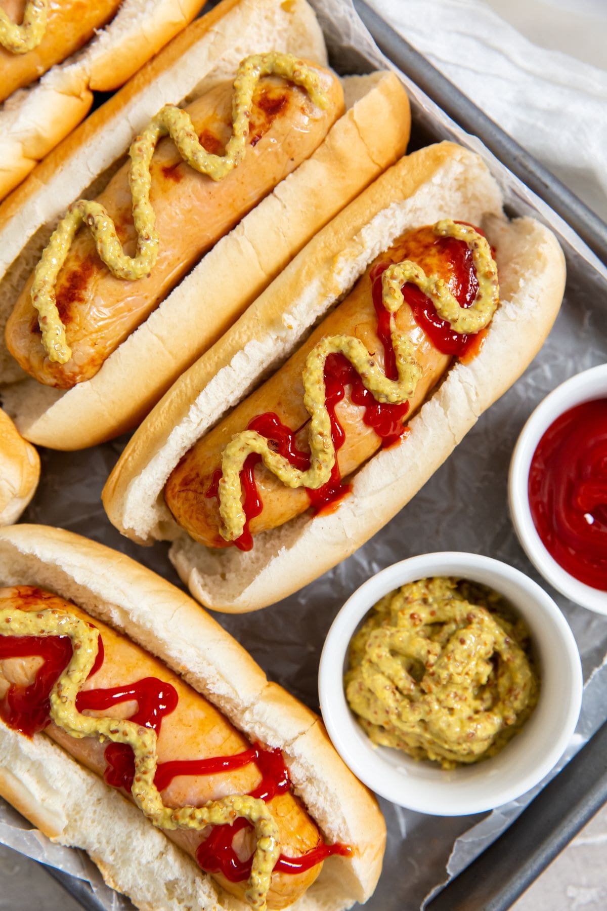 Chicken sausage in hot dog buns. mustard and ketchup on them