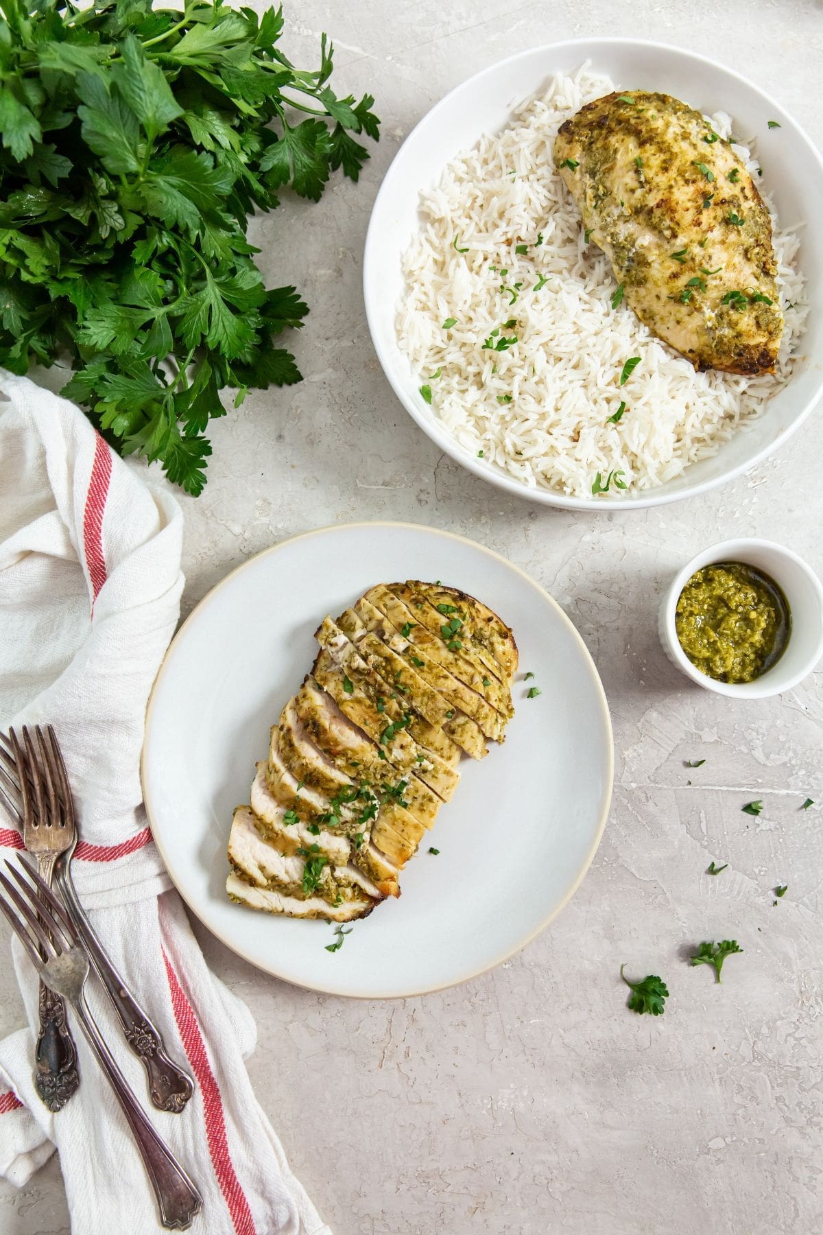 The Best Air Fryer Chicken Breast Recipes a Plate with Air Fryer Pesto Chicken Next to a Bowl of White Rice Topped with Air Fryer Pesto Chicken