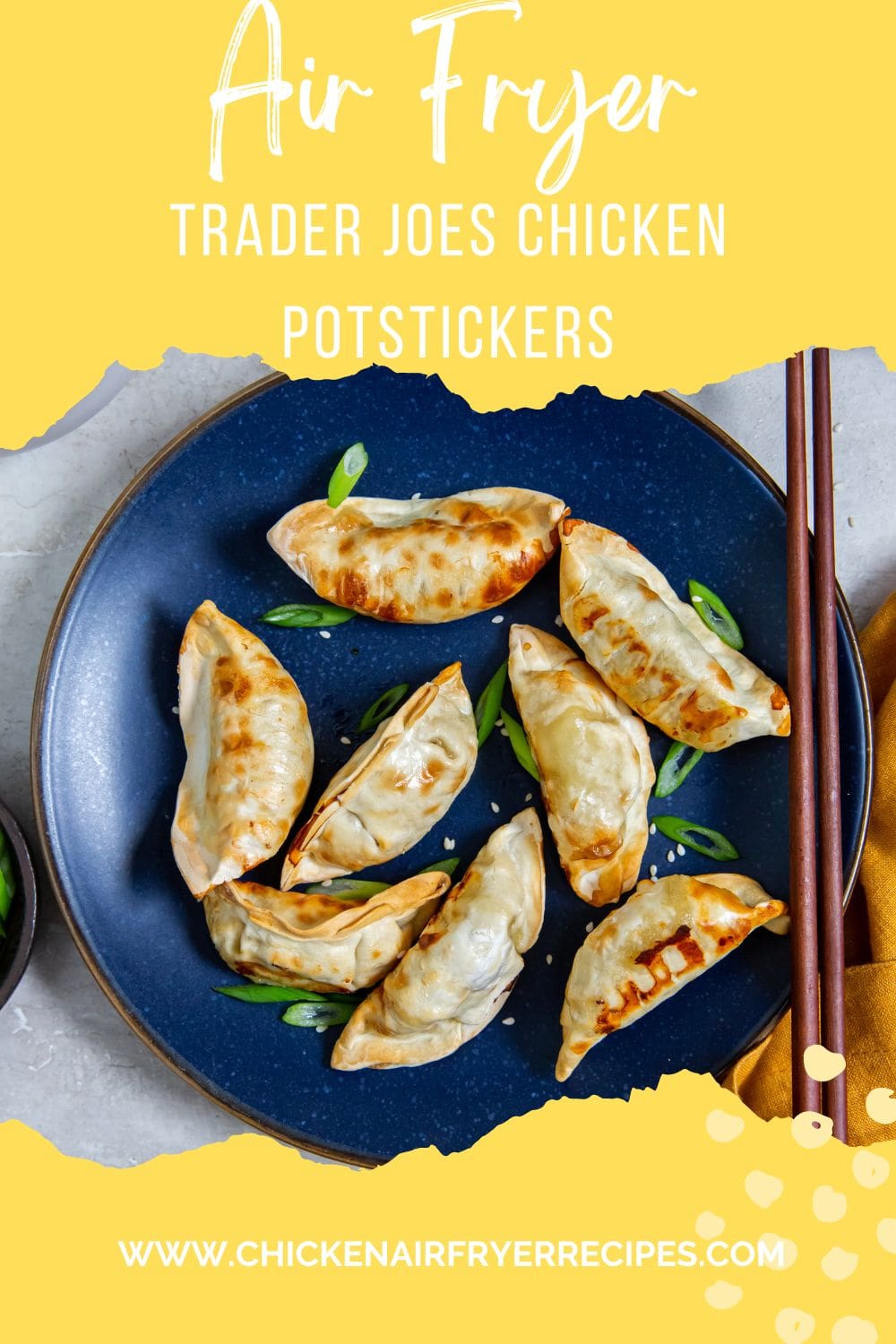 Blue plate with potstickers and scallions on it. chopsticks on the side of the plate. orange towel next to it.