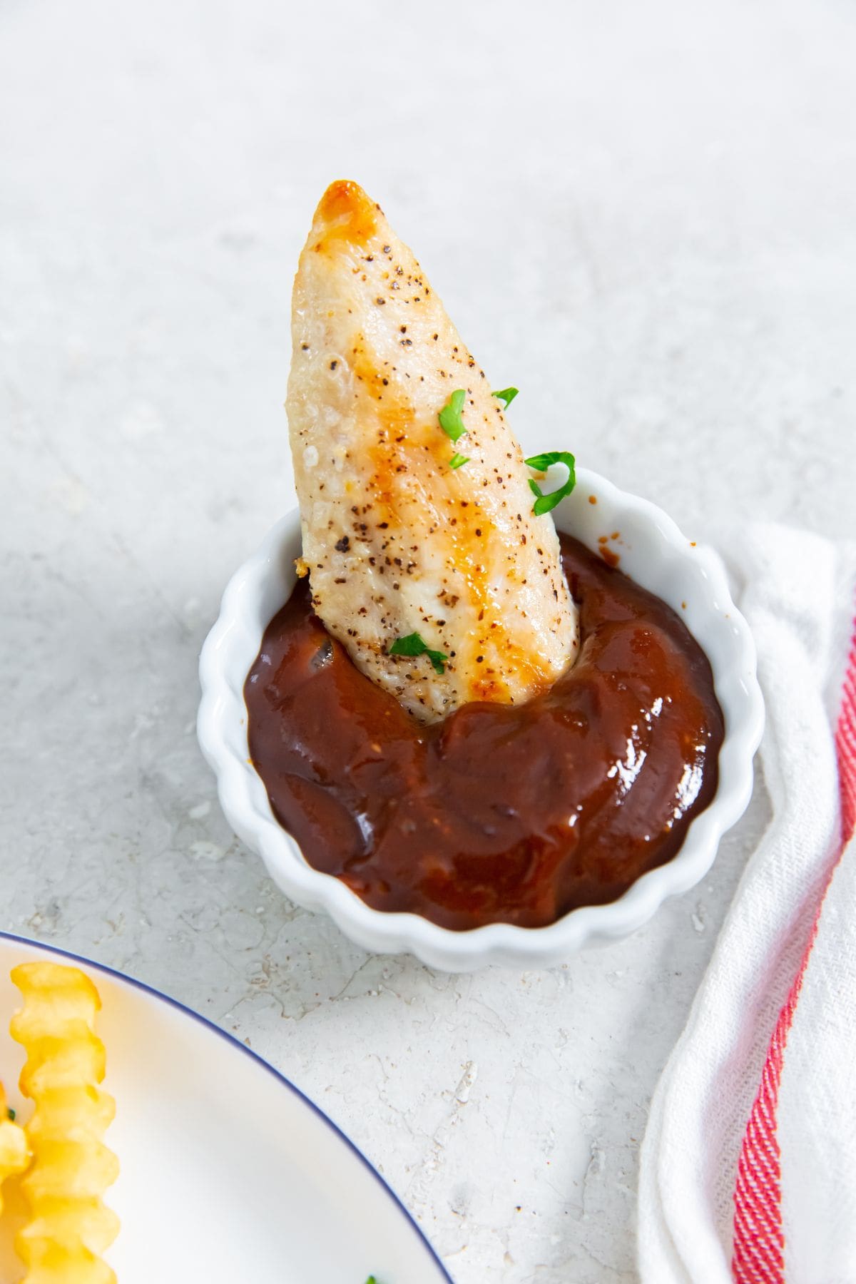 chicken tenders dunked in BBQ Sauce.