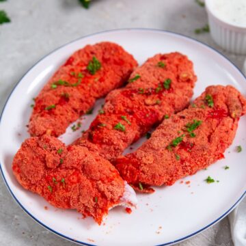 chicken on a plate Cheetos bag next to it