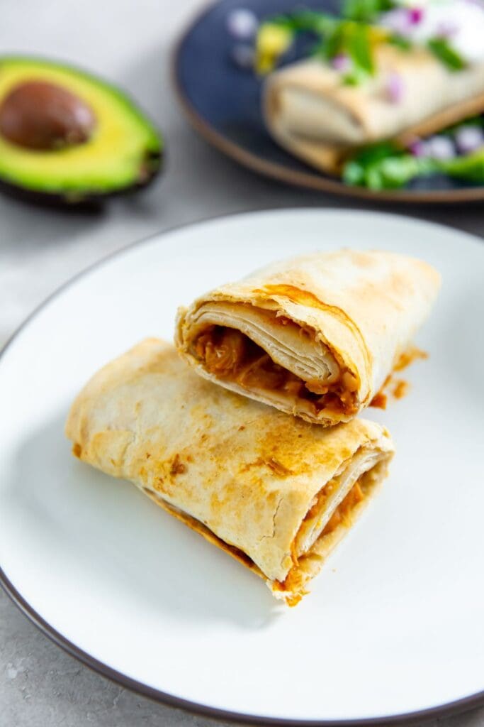 Air Fryer Trader Joe's chicken burritos on a white plate.