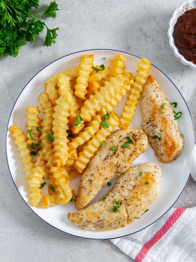 plate with chicken and fries. BBQ sauce in the back