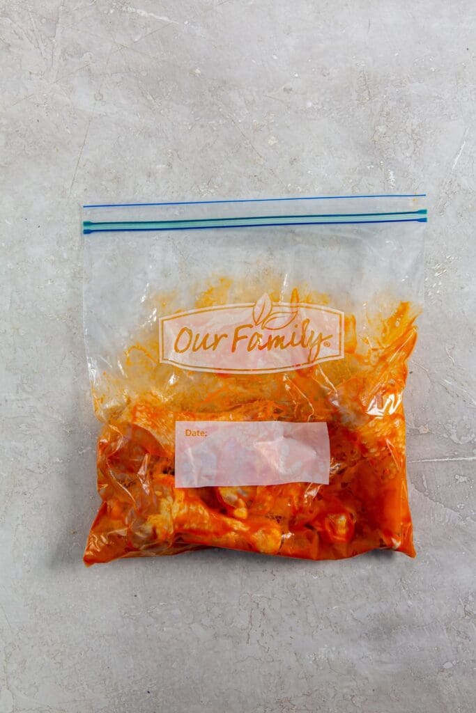 chicken and buffalo sauce inside a ziplock bag