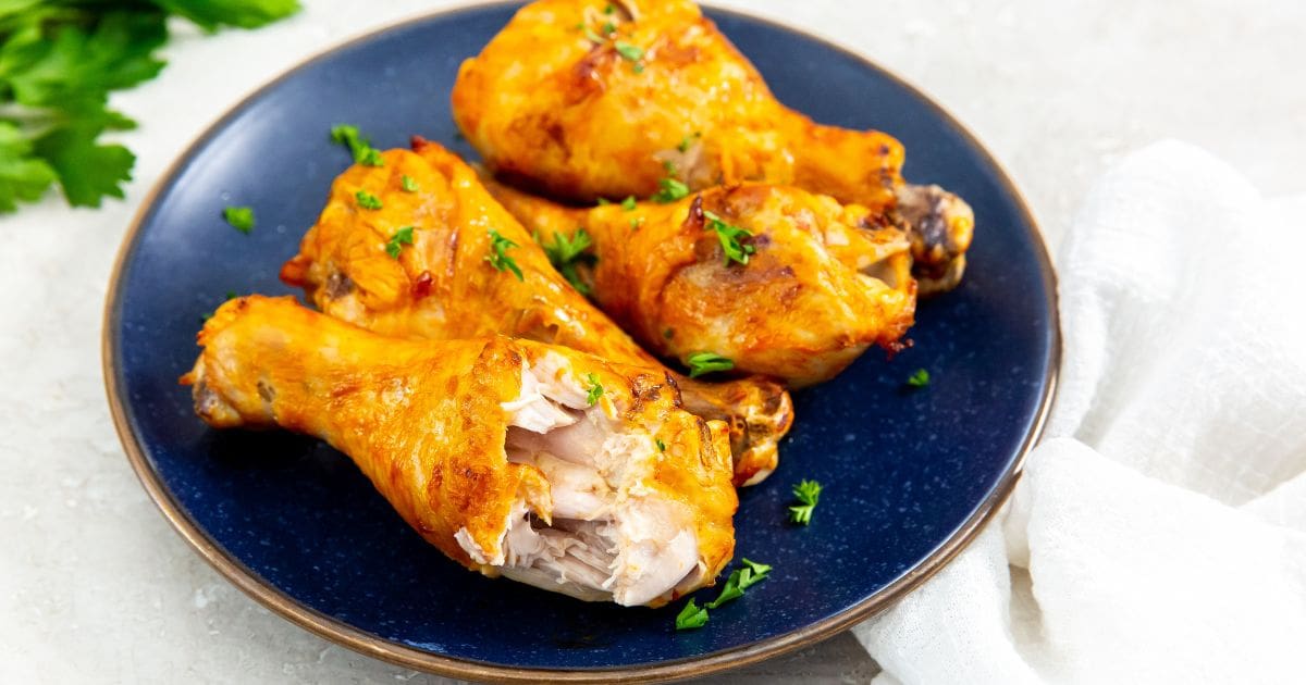 chicken on a blue plate with parsley and white towel next to it