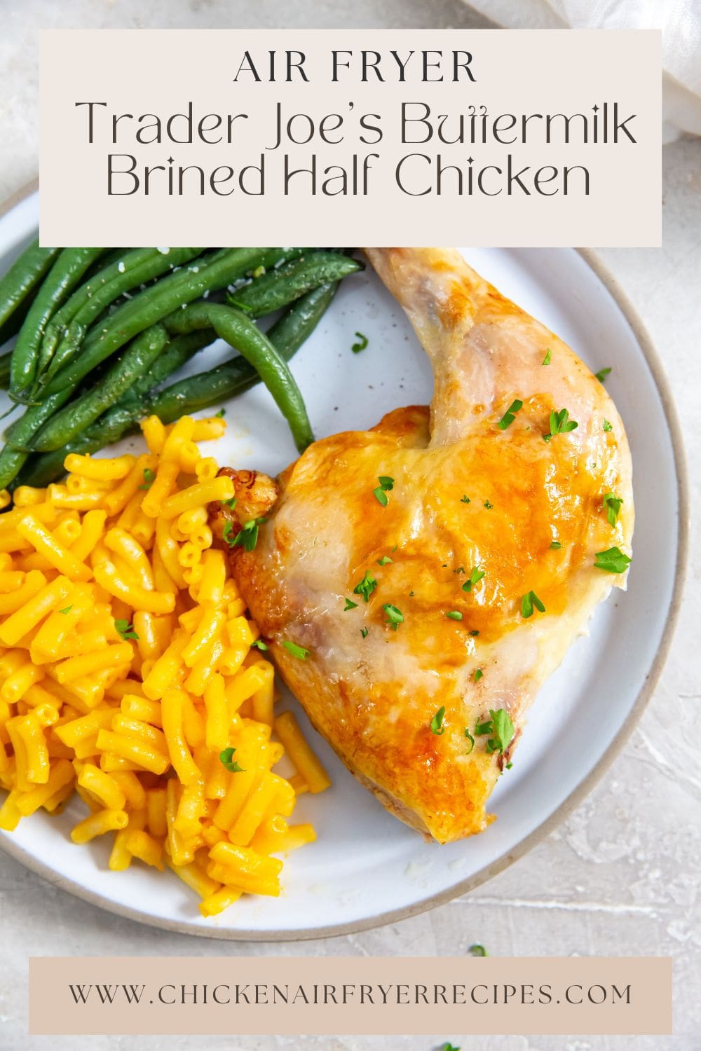 White plate with chicken Mac and cheese, and green beans on it.