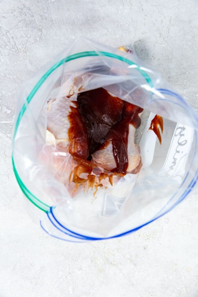 chicken and bbq sauce inside a ziplock bag