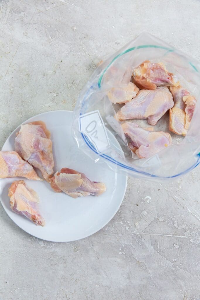 chicken in a ziplock bag and chicken on a plate.