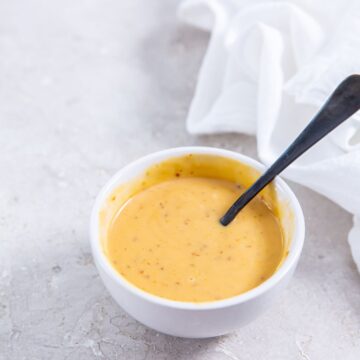 white bowl with sauce and spoon inside