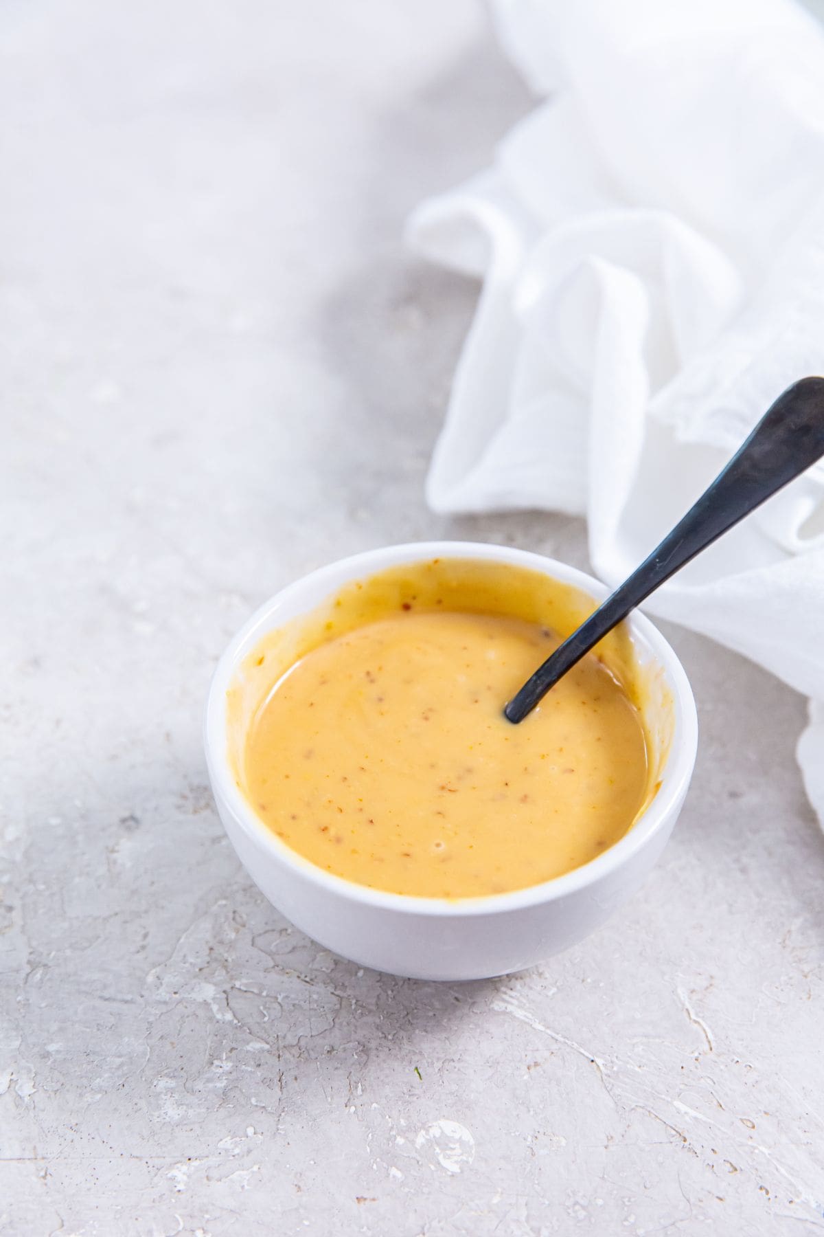 white bowl with copycat chick-fil-a sauce and spoon inside