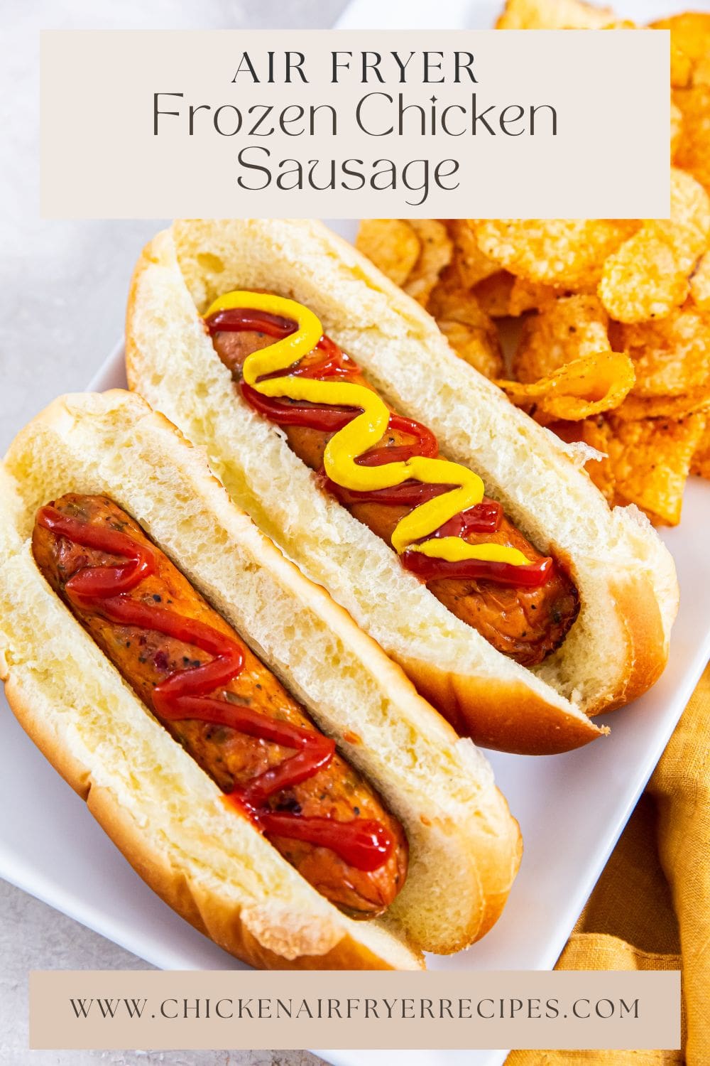 chicken sausages topped with ketchup and served alongside crispy potato chips.