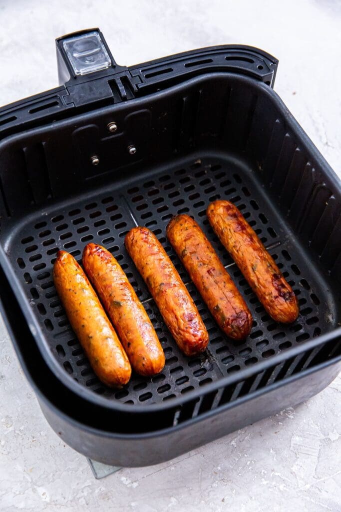 Frozen sausages cooked in an air fryer.