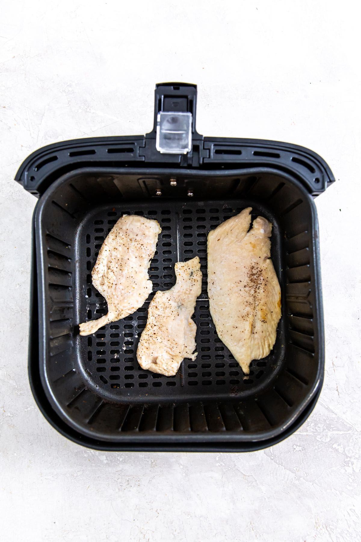 chicken breast cooked in an air fryer with crispy perfection.