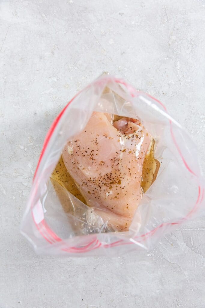 Ziplock bag with chicken breast and Italian dressing