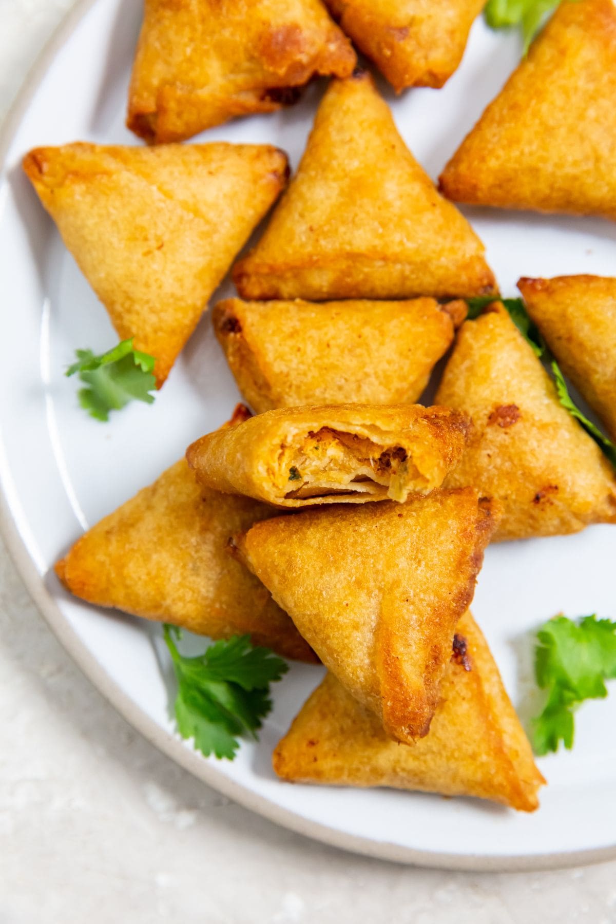 Chicken Tikka Samosas served on a white plate.