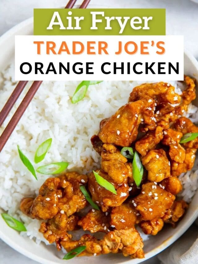 Air frying trader joe's orange chicken served over white rice, garnished with sesame seeds and green onions, with chopsticks on the side.