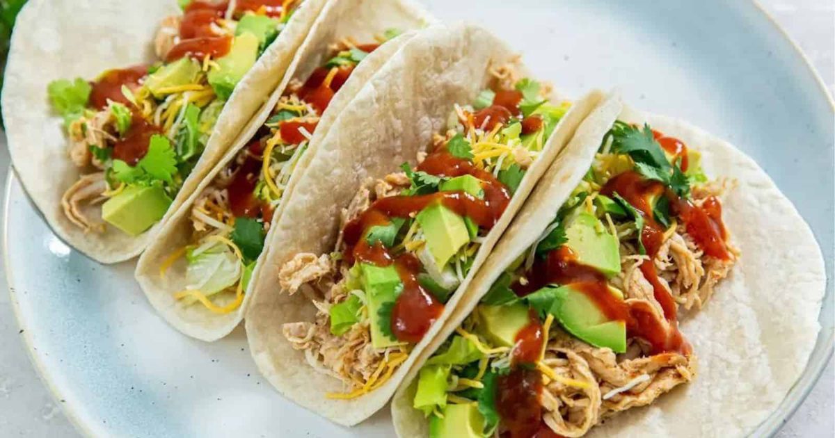 Air-Fried Chicken Dishes Air Fryer Chicken Tacos on a Plate Topped with Avocado Chunks and Hot Sauce