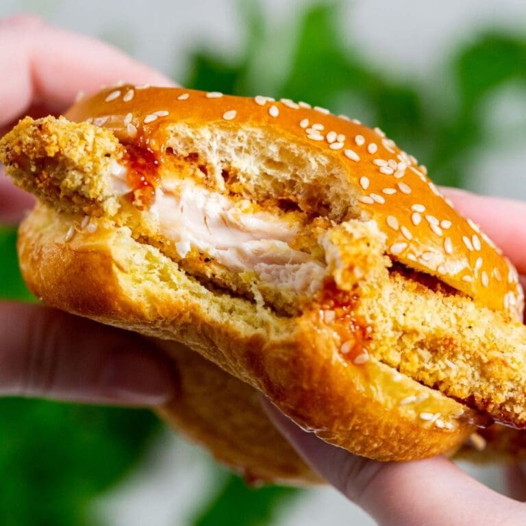 Chicken Recipes That Picky Eaters Will Love Close up of a Katsu Chicken Sandwich with a Bite Taken in a Person's Hands