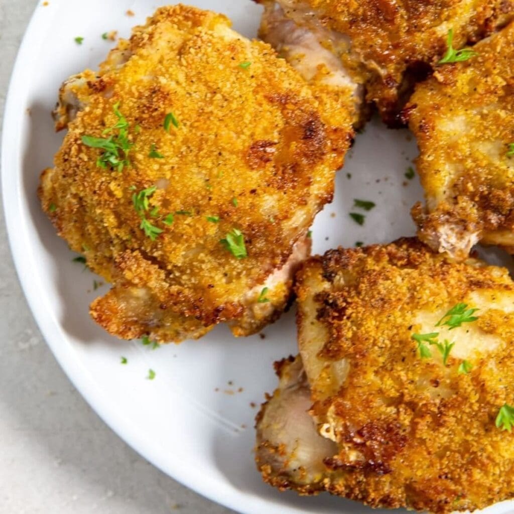 Air Fryer Dishes Close up of Breaded Chicken Thighs on a Plate